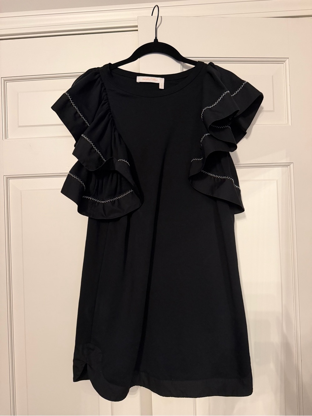 See By Chloé 100% Cotton black dress with oversized ruffle sleeve.